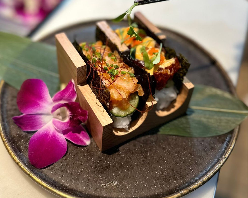 Sushi tacos plated in wooden holders